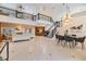 Open-concept living and dining area with high ceilings, staircase, and views to the kitchen at 116 9Th E St, Tierra Verde, FL 33715