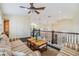 Cozy loft with comfortable seating and a view of the lower level, perfect for a relaxing retreat at 116 9Th E St, Tierra Verde, FL 33715