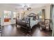Main bedroom featuring hardwood floors, natural light, a ceiling fan, and furniture at 116 9Th E St, Tierra Verde, FL 33715