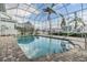 Relaxing enclosed pool area with a pristine pool, brick pavers, and well-maintained landscaping for outdoor enjoyment at 116 9Th E St, Tierra Verde, FL 33715