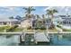Waterfront home featuring a private dock, screened lanai, and lush landscaping, all with access to the serene canal at 116 9Th E St, Tierra Verde, FL 33715