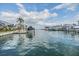 View of a waterfront community with boats docked and luxury homes in the background, showcasing a tranquil and serene canal at 116 9Th E St, Tierra Verde, FL 33715