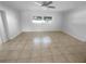 Bedroom featuring tile flooring, a ceiling fan, and a bright window at 11779 82Nd Ter, Seminole, FL 33772