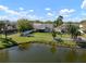 Aerial view of a home and backyard with a white picket fence overlooking a pond at 1224 Cressford Pl, Brandon, FL 33511