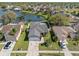 Aerial view of a charming home near a serene lake, showcasing its well-maintained yard and peaceful neighborhood at 1224 Cressford Pl, Brandon, FL 33511