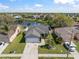 Aerial view of a charming home near a serene lake, showcasing its well-maintained yard and peaceful neighborhood at 1224 Cressford Pl, Brandon, FL 33511