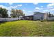The backyard features a large, fenced green area with a screened lanai, perfect for outdoor living and entertaining at 1224 Cressford Pl, Brandon, FL 33511