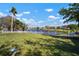Well-maintained backyard with a lush lawn and a white picket fence overlooking a pond at 1224 Cressford Pl, Brandon, FL 33511