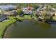 Beautiful lake view backyard with well-manicured lawn, mature trees, and white picket fence at 1224 Cressford Pl, Brandon, FL 33511