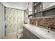 Bathroom with dual sinks, mosaic tile backsplash, and shower with curtain at 1224 Cressford Pl, Brandon, FL 33511