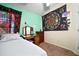 Comfortable bedroom with a full bed, wooden desk, and decorative wall hangings at 1224 Cressford Pl, Brandon, FL 33511