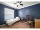 Cozy bedroom with a twin bed, accent wall, and a ceiling fan at 1224 Cressford Pl, Brandon, FL 33511