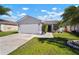 Beautiful single-story home featuring a manicured lawn, mature palm trees, and an attached garage at 1224 Cressford Pl, Brandon, FL 33511