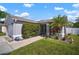 Welcoming single-story home with lush green lawn and mature landscaping framing the entrance at 1224 Cressford Pl, Brandon, FL 33511