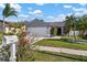 Charming single-story home featuring a two-car garage, well-manicured lawn, and lush landscaping at 1224 Cressford Pl, Brandon, FL 33511