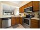 Well-equipped kitchen featuring stainless steel appliances, white countertops, and wooden cabinets at 1224 Cressford Pl, Brandon, FL 33511