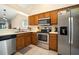 Kitchen with stainless steel appliances and wood cabinets at 1224 Cressford Pl, Brandon, FL 33511