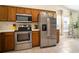 Well-lit kitchen featuring stainless steel appliances, oak cabinets, and a tile floor at 1224 Cressford Pl, Brandon, FL 33511