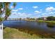 Scenic lake view showcasing the tranquil waterfront setting, lush greenery, and clear blue skies on a sunny day at 1224 Cressford Pl, Brandon, FL 33511