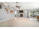 Open-concept living room featuring tile flooring, a cozy fireplace, and sliding glass doors to the outdoor patio at 1224 Cressford Pl, Brandon, FL 33511