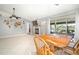 Open-concept living space with dining area adjacent to fireplace and view of backyard through sliding glass doors at 1224 Cressford Pl, Brandon, FL 33511