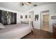 Bright main bedroom featuring vaulted ceilings, a ceiling fan, and a decorative accent wall at 1224 Cressford Pl, Brandon, FL 33511