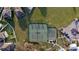 Overhead shot of tennis and basketball courts, highlighting the community's recreational facilities and parking at 12820 Bent Twig Dr, Riverview, FL 33579