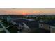 An aerial view of a residential neighborhood at sunset, with a row of houses and a colorful sky at 12820 Bent Twig Dr, Riverview, FL 33579