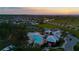 Breathtaking aerial view capturing the community's pool, tennis courts, and residential homes at sunset at 12820 Bent Twig Dr, Riverview, FL 33579
