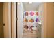 bathroom with colorful fish themed shower curtain, neutral paint, gray vanity and laminate floor at 12820 Bent Twig Dr, Riverview, FL 33579
