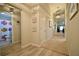 Hallway view with beach-themed decorations, featuring a view into a colorful bathroom with fish theme at 12820 Bent Twig Dr, Riverview, FL 33579