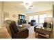 Comfortable living room features plush seating, a ceiling fan, and lots of natural light at 12820 Bent Twig Dr, Riverview, FL 33579