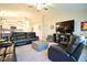 Open-concept living room with vaulted ceilings and lots of natural light flows into eat in kitchen at 12820 Bent Twig Dr, Riverview, FL 33579