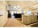 Open concept living room with kitchen island, featuring a ceiling fan, a leather sofa, and neutral paint at 12820 Bent Twig Dr, Riverview, FL 33579