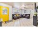 Inviting living room with tile floors, a bright yellow front door, and comfortable seating at 1311 E Cherry St, Plant City, FL 33563