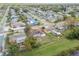 Sprawling community with homes on spacious lots and mature trees under a partly cloudy sky at 1629 Dartmouth Dr, Holiday, FL 34691