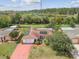 Property featuring installed solar panels, a red driveway, and lovely views of the adjacent river at 1629 Dartmouth Dr, Holiday, FL 34691