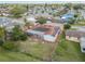 Aerial view of a home with solar panels on the roof and a sunroom surrounded by a fenced yard at 1629 Dartmouth Dr, Holiday, FL 34691