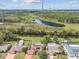 Neighborhood homes with solar panels on their roofs near a body of water surrounded by lush greenery at 1629 Dartmouth Dr, Holiday, FL 34691