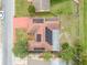 Birds eye view of roof featuring solar panels on top of red roof at 1629 Dartmouth Dr, Holiday, FL 34691