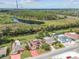 Waterfront community with mature trees, nearby lake, and homes with solar panels on their roofs at 1629 Dartmouth Dr, Holiday, FL 34691
