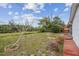 Well-manicured backyard, framed by a fence and lush greenery for ultimate privacy and enjoyment at 1629 Dartmouth Dr, Holiday, FL 34691