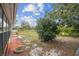 Expansive backyard featuring mature trees, manicured lawn, and a cozy patio area perfect for outdoor enjoyment at 1629 Dartmouth Dr, Holiday, FL 34691