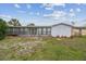 The spacious backyard features a sunroom, providing a seamless indoor-outdoor living experience at 1629 Dartmouth Dr, Holiday, FL 34691