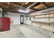 Unfinished basement area with laundry machines, open ceilings, shelving, and storage capabilities at 1629 Dartmouth Dr, Holiday, FL 34691