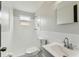 Clean bathroom featuring a shower, toilet, and vanity with modern fixtures and a small window at 1629 Dartmouth Dr, Holiday, FL 34691