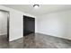 Bedroom with fresh white paint, dark accents, tile floors and a view to the hallway at 1629 Dartmouth Dr, Holiday, FL 34691
