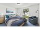 Comfortable bedroom with a bed, blue accents, and a large window with a backyard view at 1629 Dartmouth Dr, Holiday, FL 34691