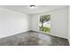 Bright bedroom with tile flooring, white walls, and a window with a picturesque view at 1629 Dartmouth Dr, Holiday, FL 34691