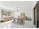 Elegant dining room featuring a large window, stylish furniture, and modern lighting fixture at 1629 Dartmouth Dr, Holiday, FL 34691